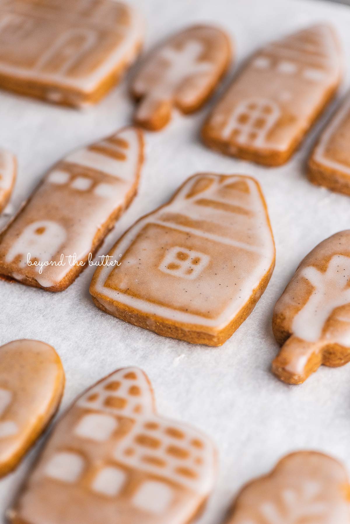 Soft and chewy gingerbread cookies lined up in rows on a white marbled background | © Beyond the Butter, LLC®
